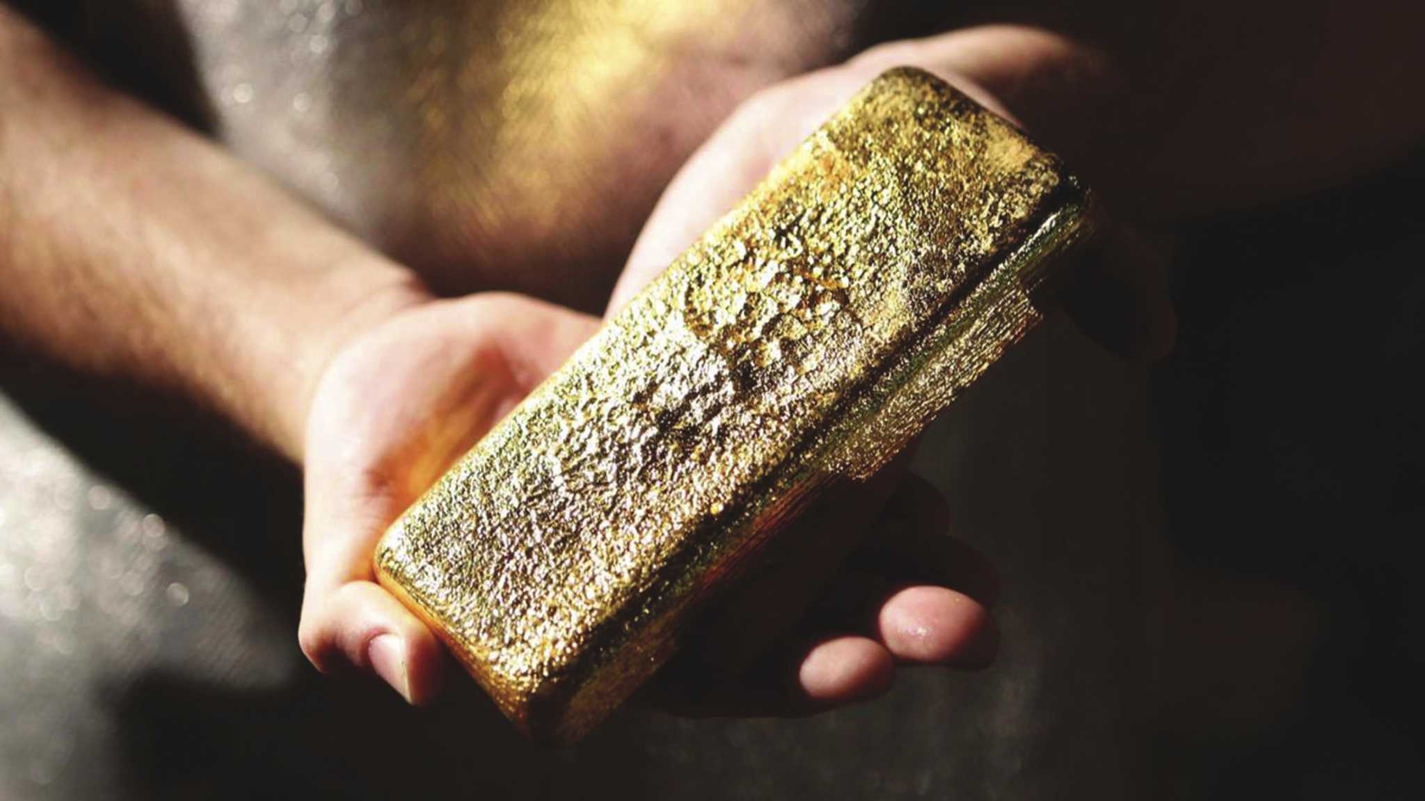 A gold bar held in their hands